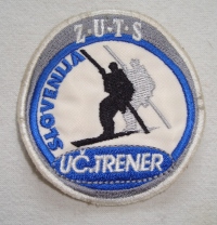 Našitek učitelj trener (2004). Vse našitke je oblikoval Sandi Murovec – Muri.